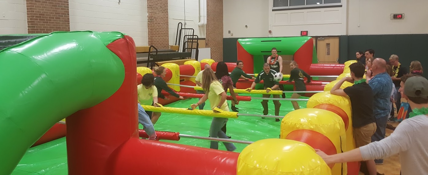 Kids playing in inflatable human foosball indoor